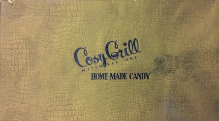 Image showing the brown lid of the Cosy Grill candy box featuring the words "Cosy Grill, Mitchell, Ont., Homemade Candy"