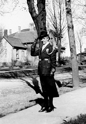 Black and white photograph of a woman wearing a junior red cross uniform